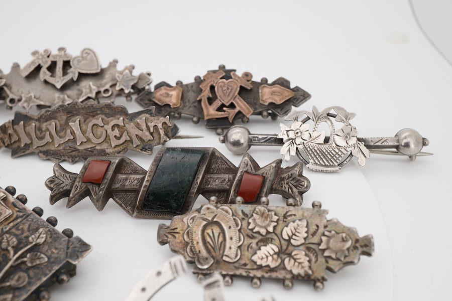Ten assorted late 19th/early 20th century silver brooches, including three with names, Baby, Millicent and Ellen, together with five other white metal brooches including Scottish hardstones, a coin set stick pin, hardsto